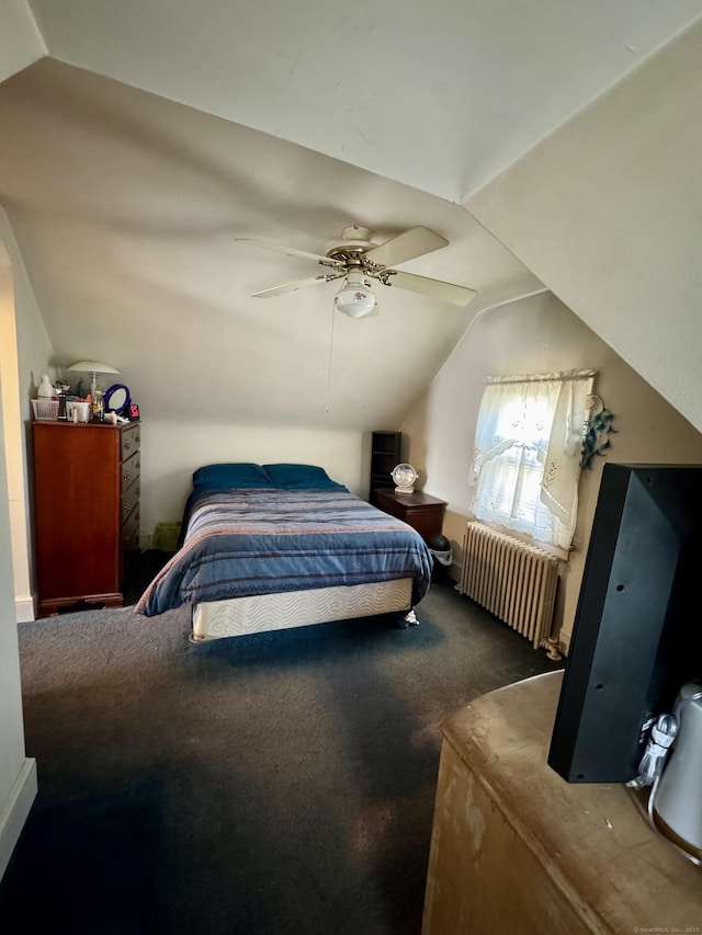 bedroom with a ceiling fan, vaulted ceiling, carpet, and radiator