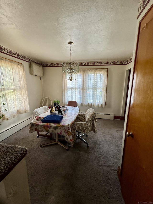 dining space with baseboard heating, carpet flooring, and a textured ceiling