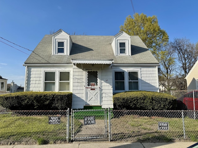 cape cod home with a gate, a fenced front yard, roof with shingles, and a front yard