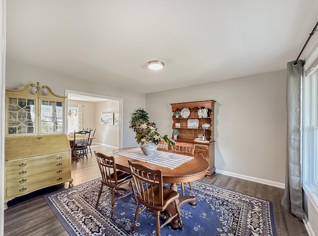 dining room with baseboards and wood finished floors
