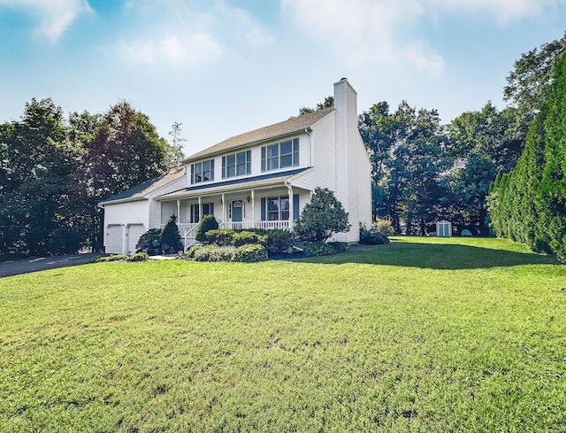 traditional home featuring a porch, a chimney, a garage, aphalt driveway, and a front lawn
