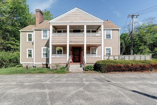 2951 Winsted Rd, Torrington, CT 06790 - view of property with a balcony, a porch, a chimney, and roof with shingles