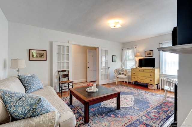 2951 Winsted Rd, Torrington, CT 06790 - living area featuring wood finished floors and radiator