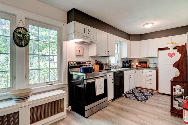 2951 Winsted Rd, Torrington, CT 06790 - kitchen with stainless steel electric range oven, under cabinet range hood, black dishwasher, freestanding refrigerator, and a sink
