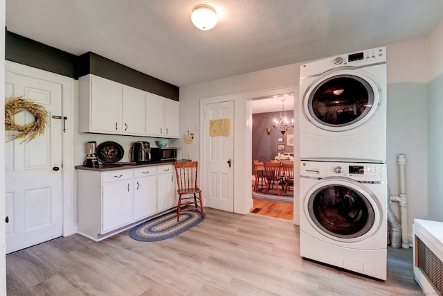 2951 Winsted Rd, Torrington, CT 06790 - laundry room with stacked washer / dryer, light wood-style flooring, and a chandelier