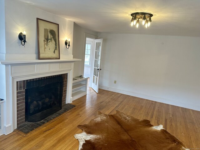 2951 Winsted Rd, Torrington, CT 06790 - unfurnished living room with a fireplace, wood finished floors, and baseboards