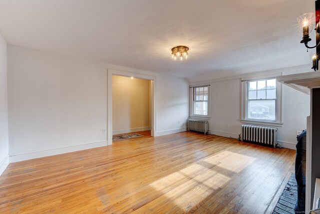 2951 Winsted Rd, Torrington, CT 06790 - spare room featuring radiator, light wood-style floors, and baseboards