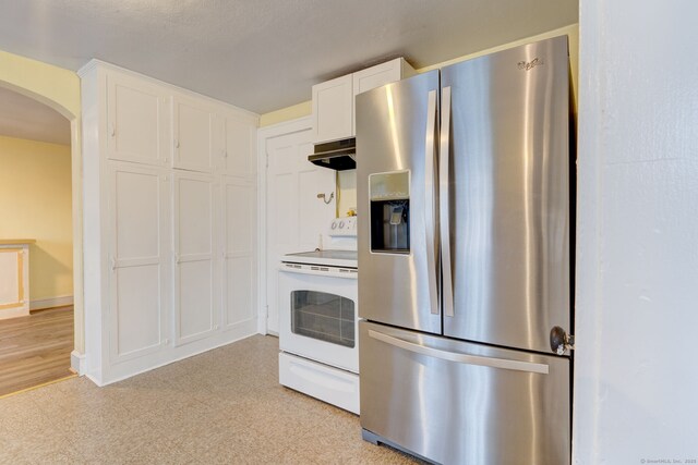 2951 Winsted Rd, Torrington, CT 06790 - kitchen with stainless steel fridge with ice dispenser, electric stove, arched walkways, light floors, and white cabinets
