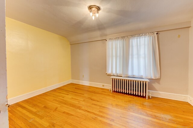 2951 Winsted Rd, Torrington, CT 06790 - empty room with radiator, wood finished floors, and baseboards