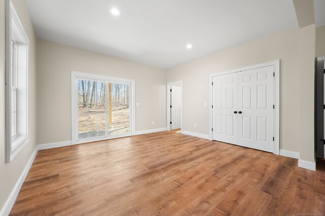 74 N Wawecus Hill Rd, Norwich, CT 06360 - unfurnished bedroom with wood finished floors, baseboards, recessed lighting, and a closet