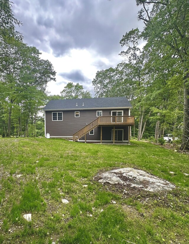 74 N Wawecus Hill Rd, Norwich, CT 06360 - back of house with a deck, stairs, and a lawn