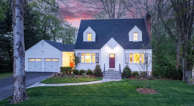 cape cod home with a chimney, asphalt driveway, an attached garage, a front lawn, and a shingled roof