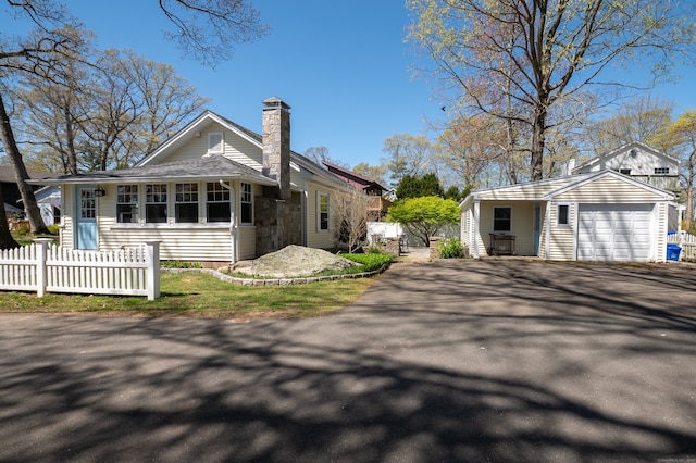 2 Bartholomew Rd, Branford, CT 06405 - view of front of home featuring a chimney, an outdoor structure, aphalt driveway, and fence