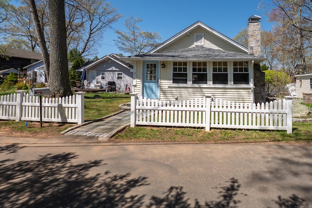 2 Bartholomew Rd, Branford, CT 06405 - view of front of house featuring a chimney and a fenced front yard