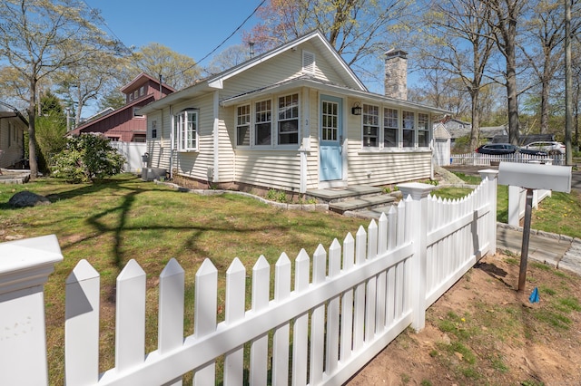 2 Bartholomew Rd, Branford, CT 06405 - view of front of property featuring a fenced front yard, a chimney, and a front yard