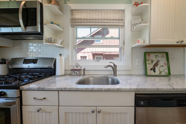 2 Bartholomew Rd, Branford, CT 06405 - kitchen featuring light stone countertops, a sink, white cabinetry, open shelves, and appliances with stainless steel finishes