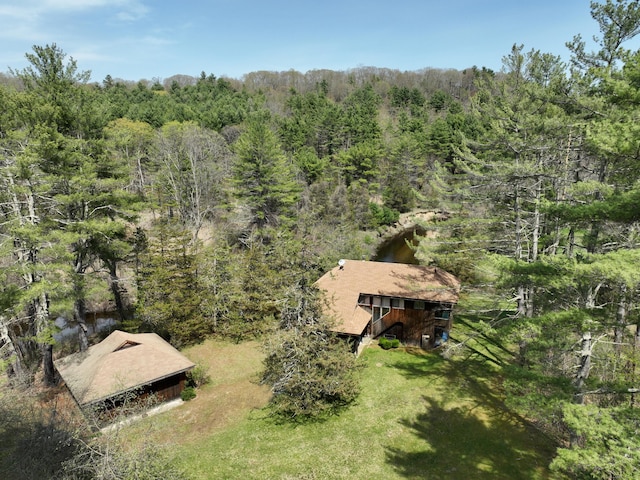 birds eye view of property with a wooded view