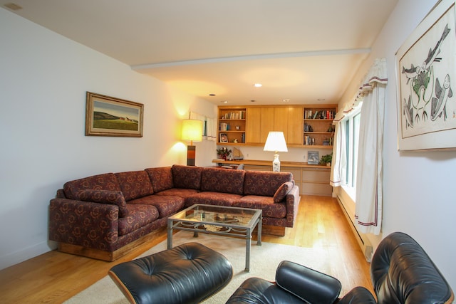 living area featuring light wood-style flooring, recessed lighting, and a baseboard heating unit