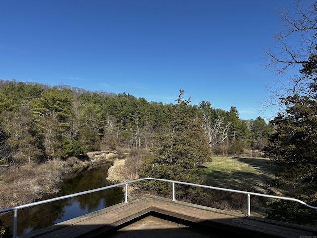 balcony featuring a view of trees