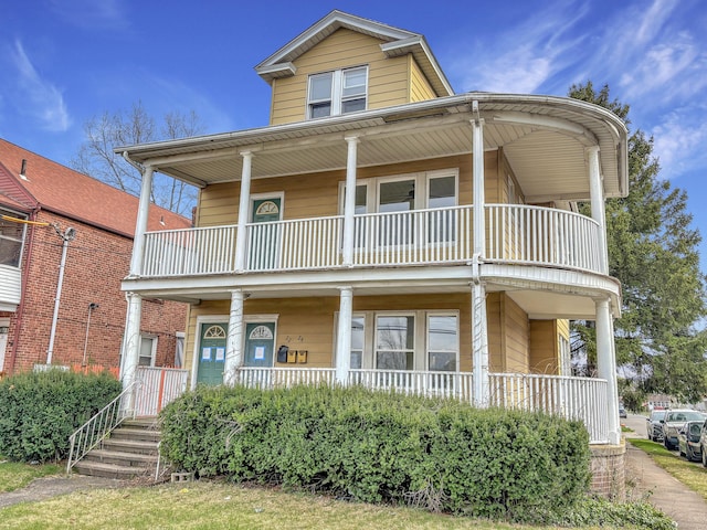 view of front of home featuring covered porch and a balcony