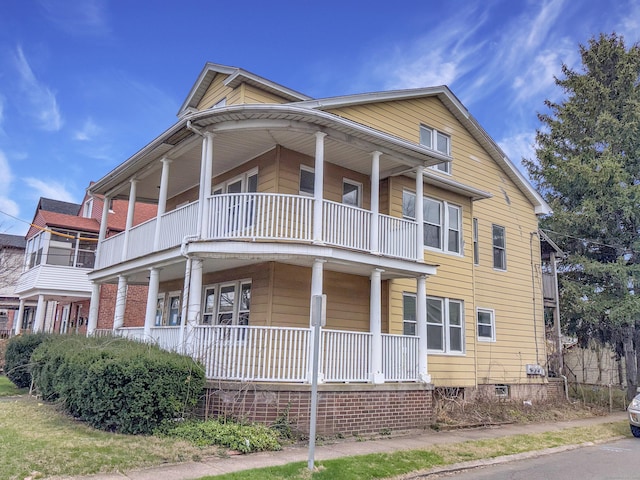 view of front of house with a porch and a balcony