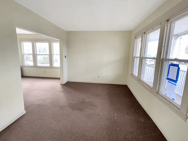 carpeted spare room with baseboards