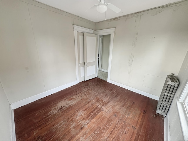 unfurnished bedroom featuring ceiling fan and wood-type flooring