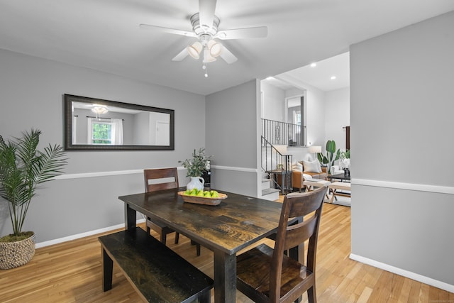 dining space with stairs, light wood-type flooring, baseboards, recessed lighting, and a ceiling fan