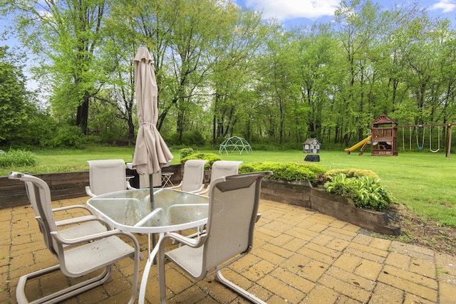 view of patio with outdoor dining space and a playground