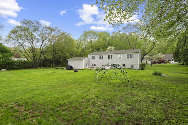 back of house with a lawn
