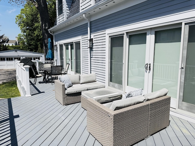 deck featuring french doors, outdoor dining area, and outdoor lounge area