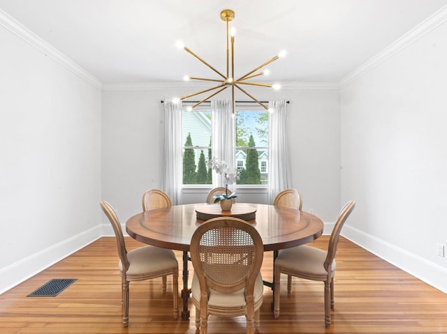 dining area featuring baseboards, a notable chandelier, crown molding, and visible vents