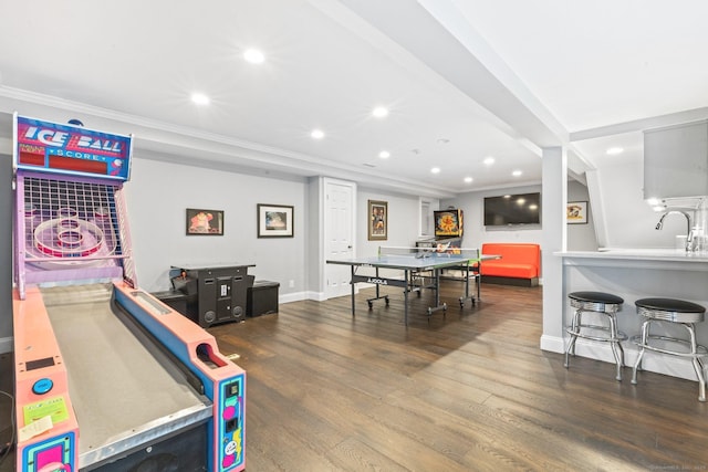 rec room with baseboards, ornamental molding, recessed lighting, and wood finished floors