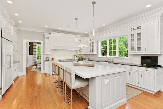 kitchen featuring white cabinetry, a kitchen island, and tasteful backsplash