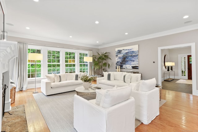 living room featuring crown molding, light wood-style flooring, and recessed lighting