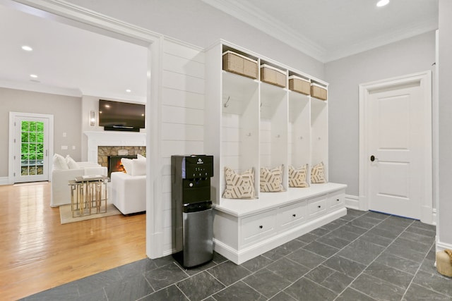 mudroom featuring a fireplace, baseboards, ornamental molding, and recessed lighting