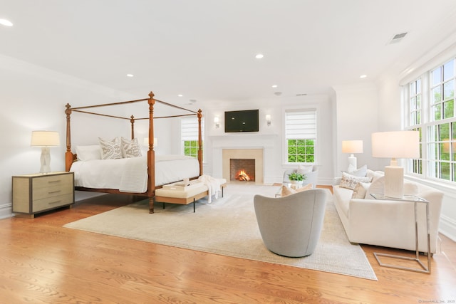 bedroom featuring crown molding, recessed lighting, visible vents, and wood finished floors