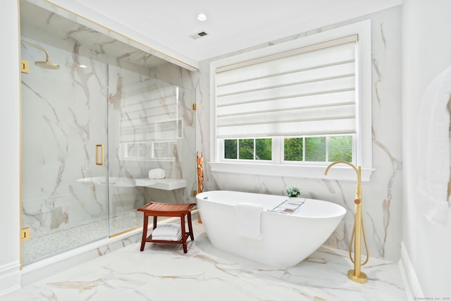 bathroom with a marble finish shower, marble finish floor, visible vents, and a freestanding bath