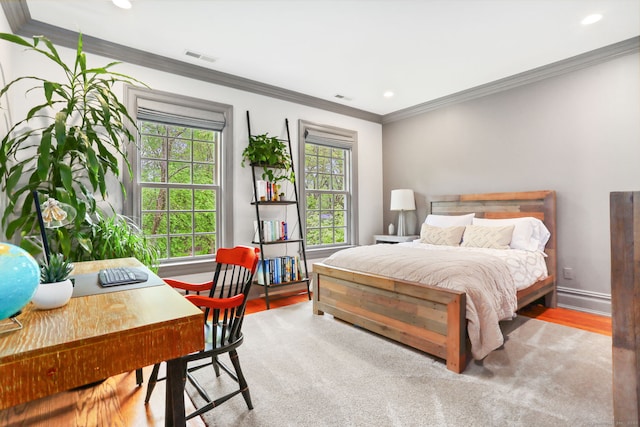 bedroom featuring wood finished floors, crown molding, visible vents, baseboards, and recessed lighting