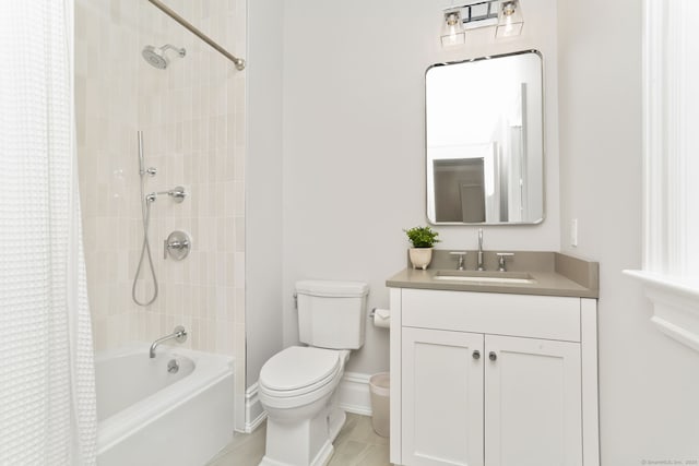 bathroom with toilet, baseboards, shower / tub combo, and vanity
