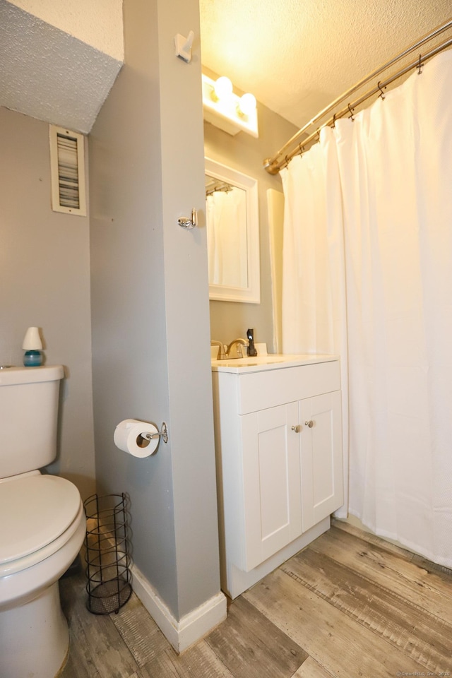 108 New Litchfield St, Torrington, CT 06790 - bathroom with a textured ceiling, wood finished floors, vanity, and a shower with shower curtain