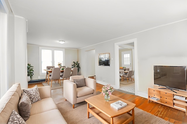 108 New Litchfield St, Torrington, CT 06790 - living room with wood finished floors, plenty of natural light, and a baseboard radiator