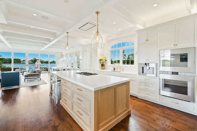 25 Tokeneke Trl, Darien, CT 06820 - kitchen with a sink, open floor plan, dark wood finished floors, beam ceiling, and stainless steel appliances
