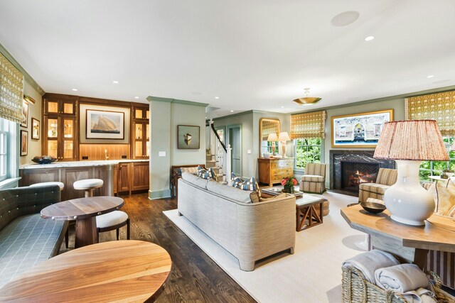 25 Tokeneke Trl, Darien, CT 06820 - living area featuring dark wood-style floors, ornamental molding, stairway, a fireplace, and recessed lighting