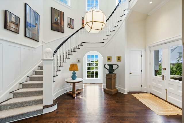 25 Tokeneke Trl, Darien, CT 06820 - entrance foyer featuring a towering ceiling, a decorative wall, stairs, wood finished floors, and french doors