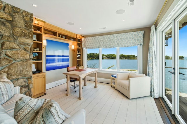 25 Tokeneke Trl, Darien, CT 06820 - living area featuring a water view, light wood finished floors, a desk, and baseboards
