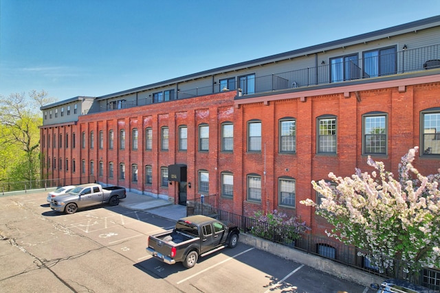 view of property featuring uncovered parking