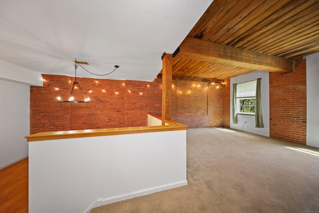 interior space featuring brick wall and baseboards