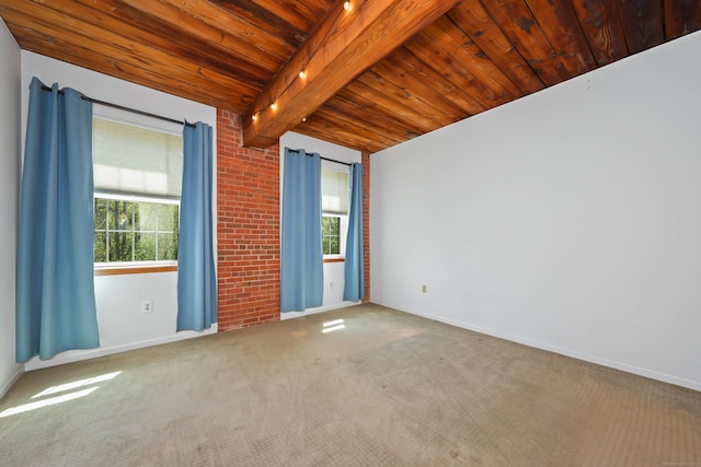 spare room featuring carpet floors, wood ceiling, beamed ceiling, and baseboards