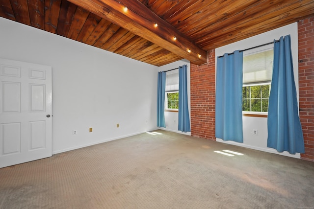unfurnished room with beam ceiling, a wealth of natural light, and carpet